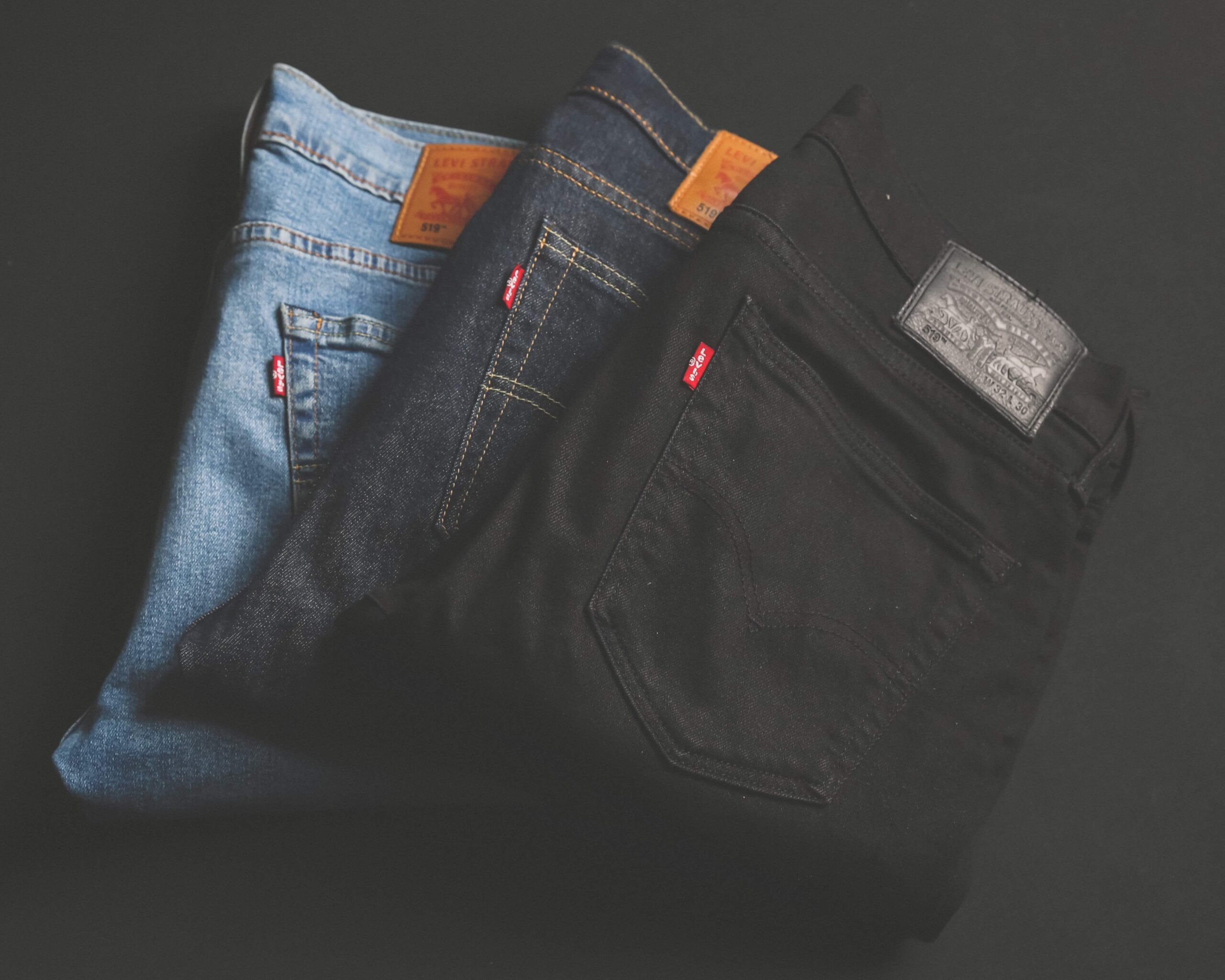 three Levis: black jeans, dark wash jeans, light wash jeans.